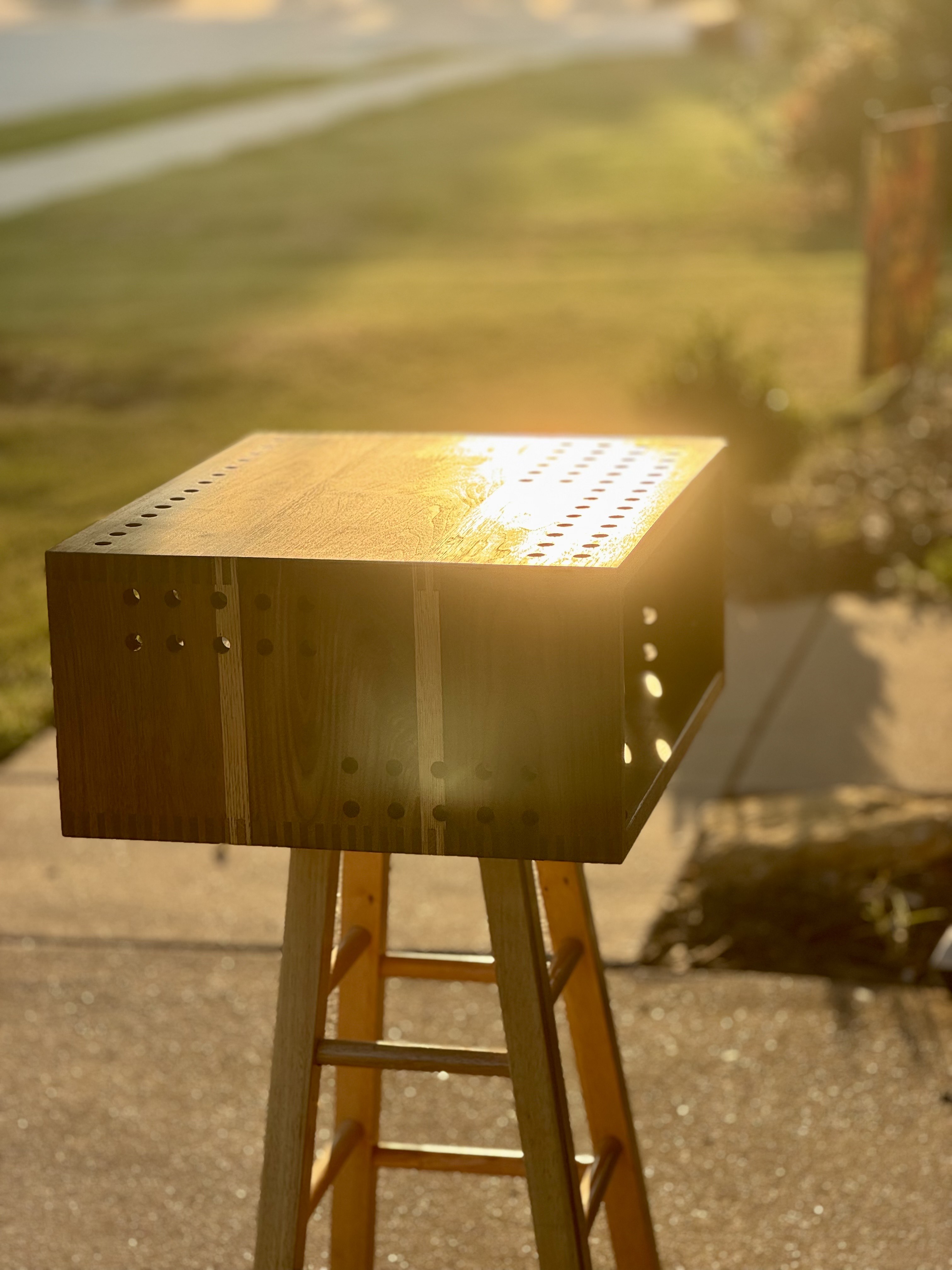 Finished wood audio enclosure shown in sunlight