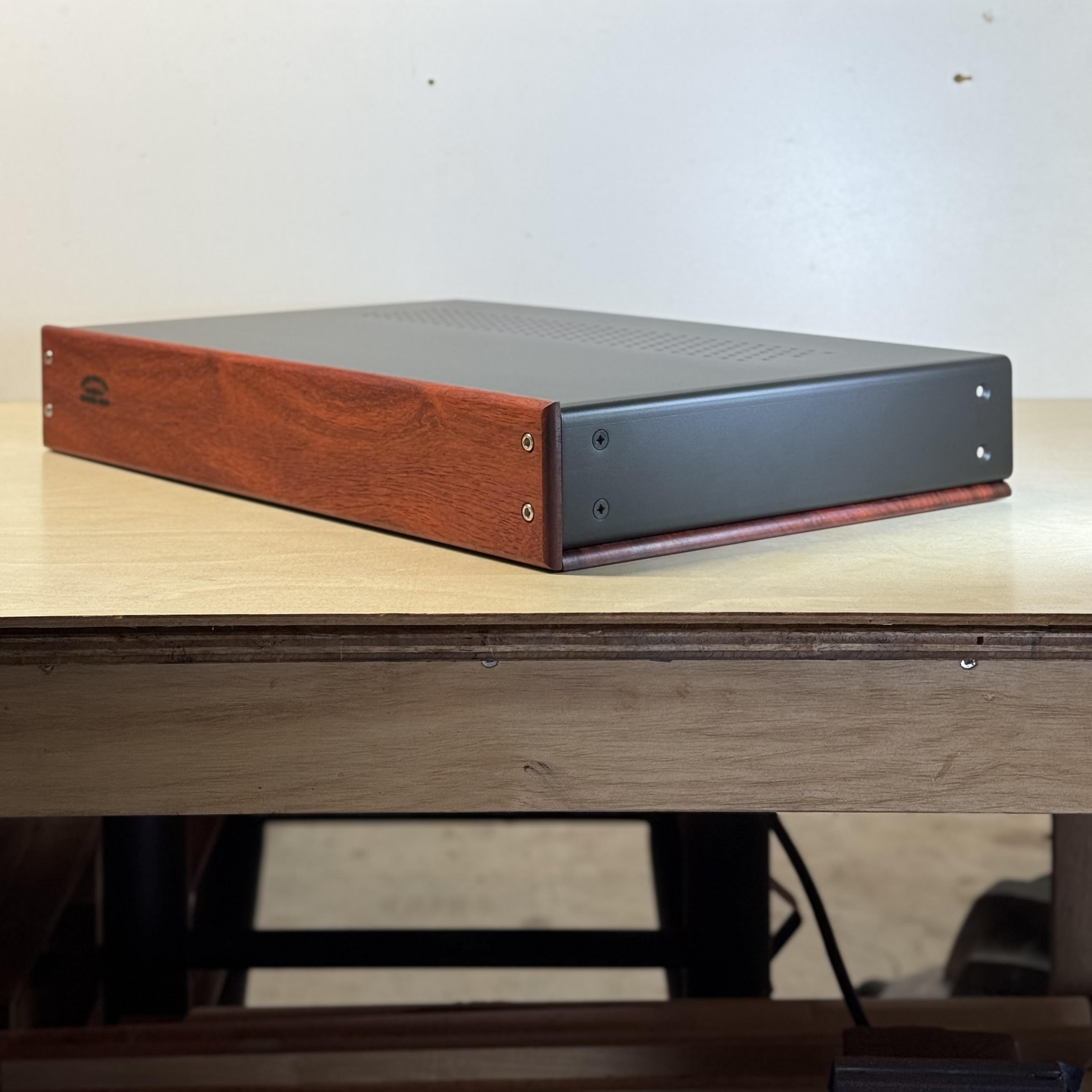 Square view of a handcrafted wood audio enclosure corner and grain